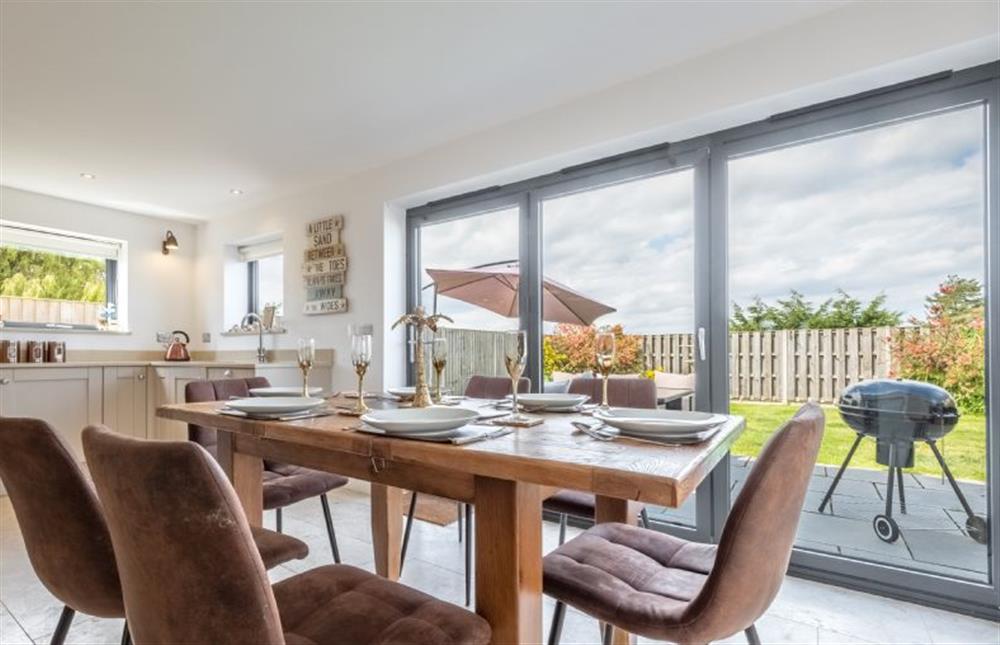 Comfortable dining area with a view of the garden at Wynholme, Holme-next-the-Sea