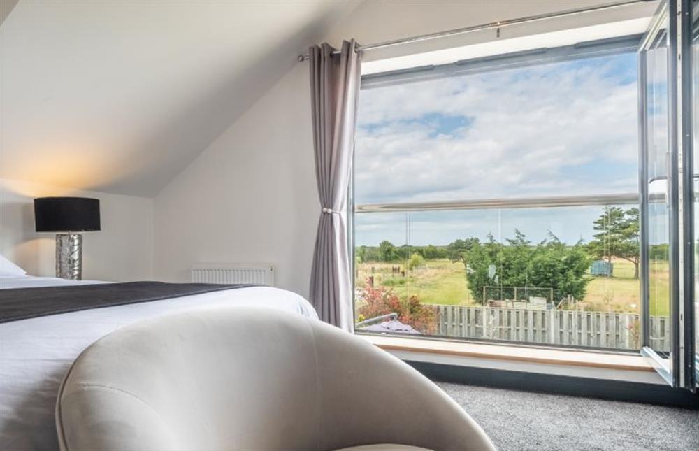 Enjoy the far reaching views from the Juliet balcony at Wynholme, Holme-next-the-Sea