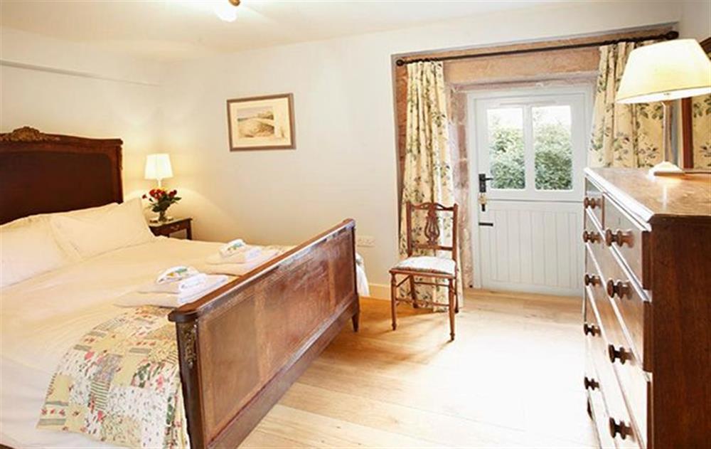 Double bedroom with 5’ bed and an en-suite bathroom with a separate power shower at Wythburn Cottage, Nr Greystoke