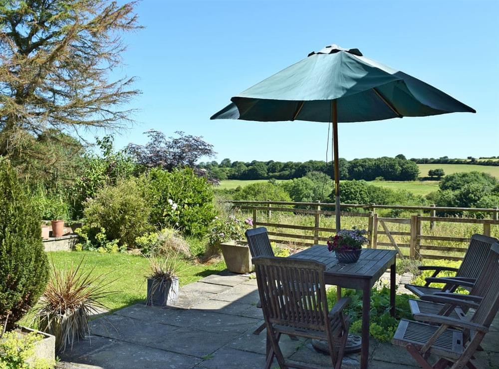 Small lawned garden with patio at Y Beudy in Crymych, Pembrokeshire, Dyfed