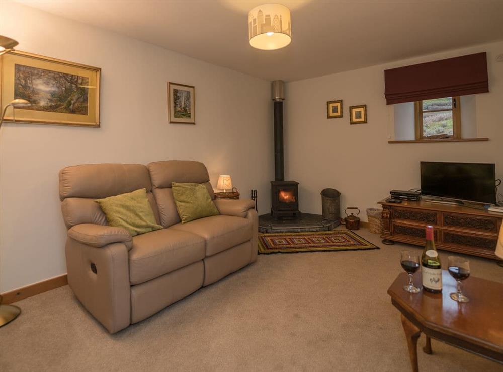 Sitting room with wood burner at Y Beudy in Pwllglas, near Ruthin, Denbighshire