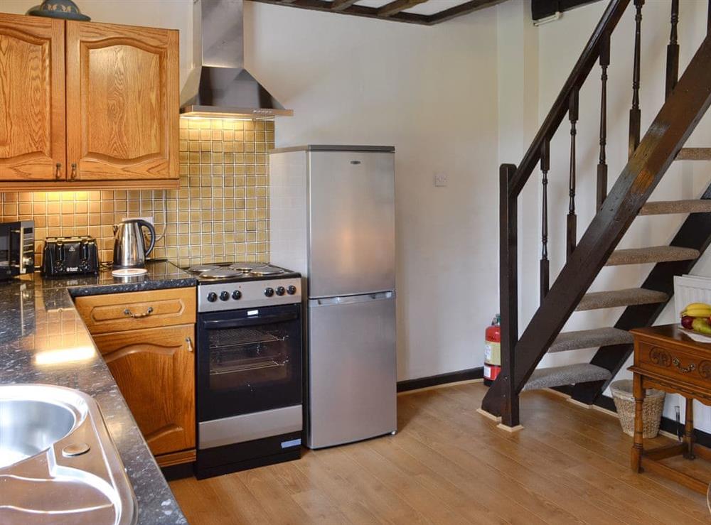 Spacious kitchen with stairs to upper level at Y Bwthyn in Bala, Gwynedd