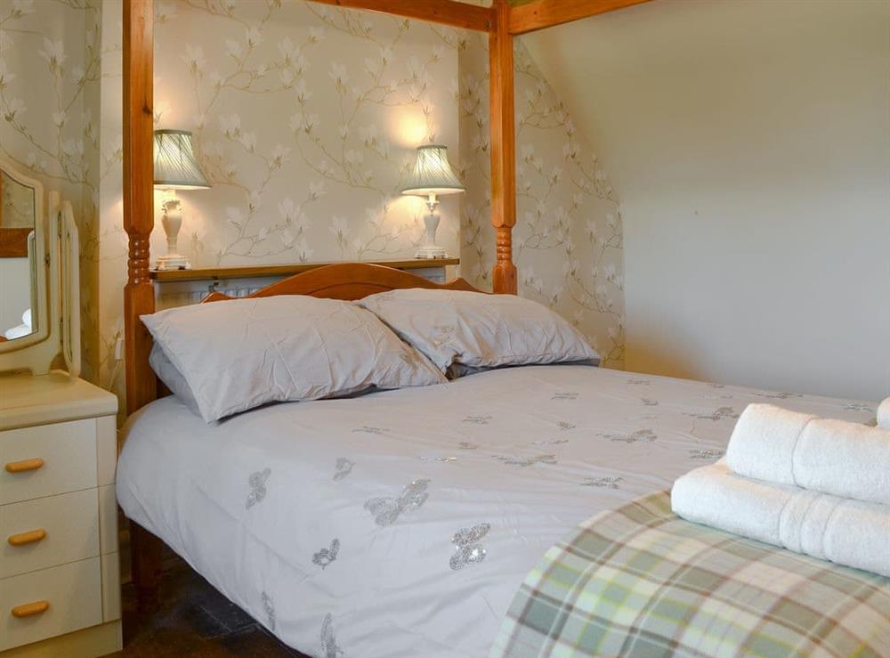 Relaxing four poster bedroom at Y Bwthyn in Llandygai, near Bangor, Gwynedd