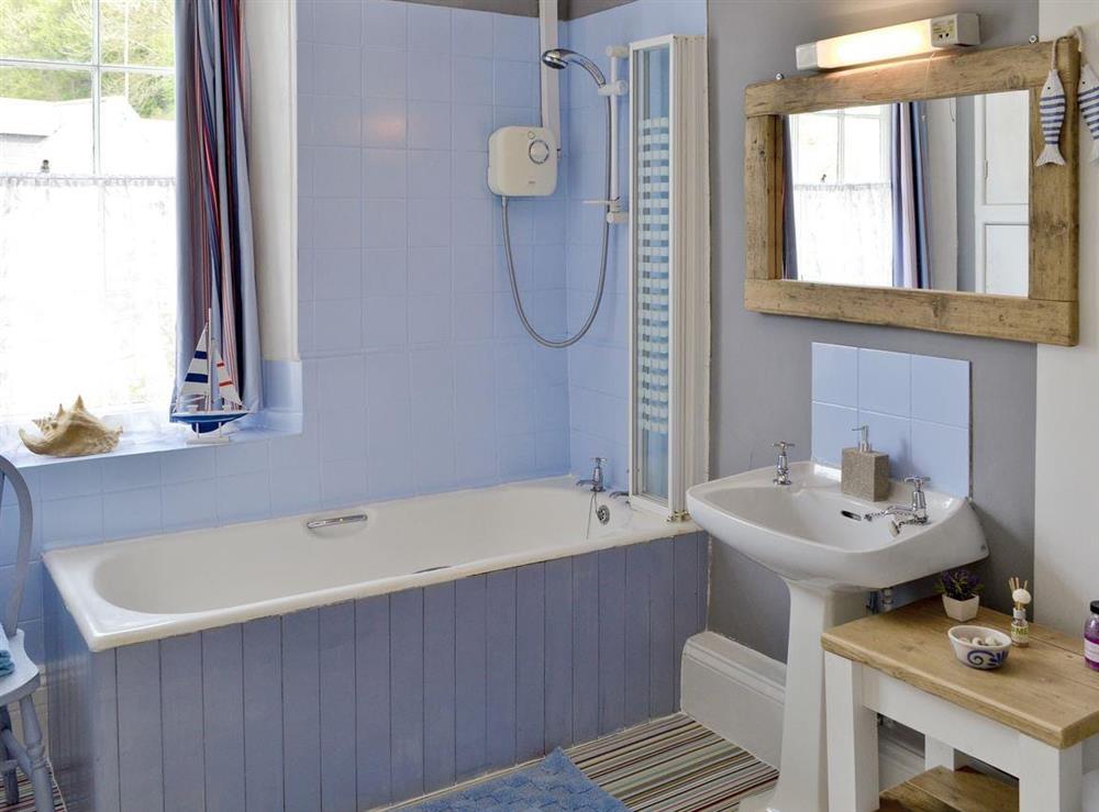 Family bathroom with shower over bath at Yawl House in Uplyme, near Lyme Regis, Devon