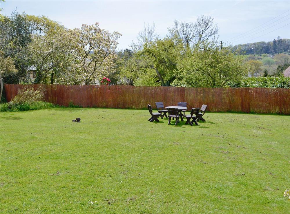 Large lawned garden with furnished area for sitting out at Yawl House in Uplyme, near Lyme Regis, Devon