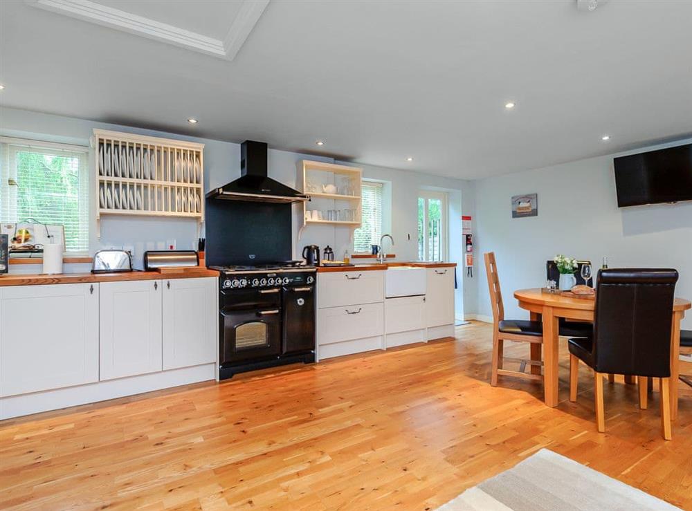 Practical dining and kitchen areas at Coachmans Cottage, 