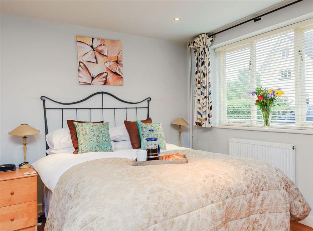 Romantic bedroom with antique style double bed at Coachmans Cottage, 