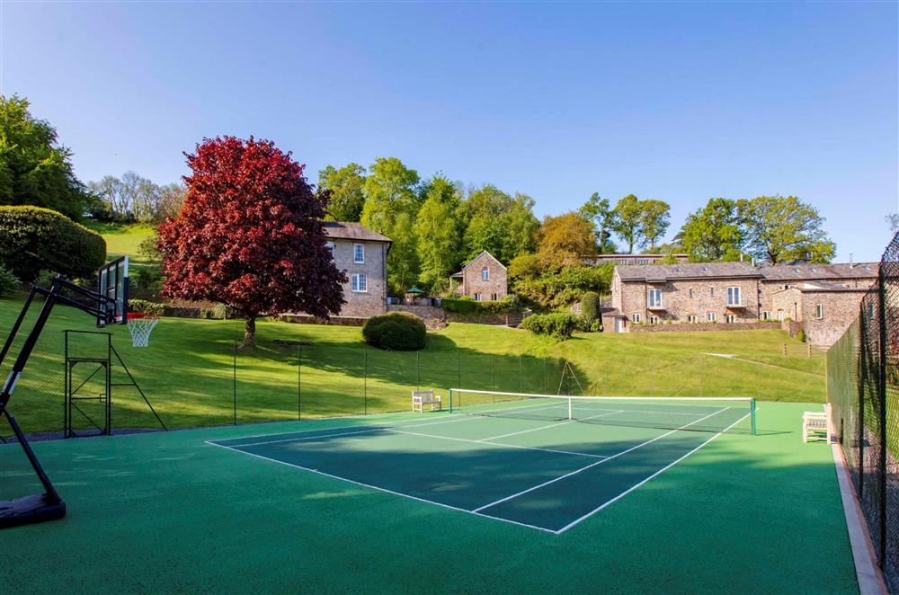 The full-size tennis court, available for guests to use at Yennadon Cottage, Dartmouth