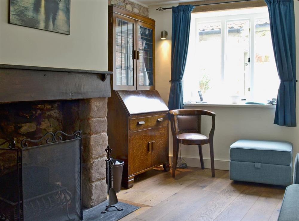 Homely living/dining room with beams and open fire at Yeomans Cottage in Wells, Somerset