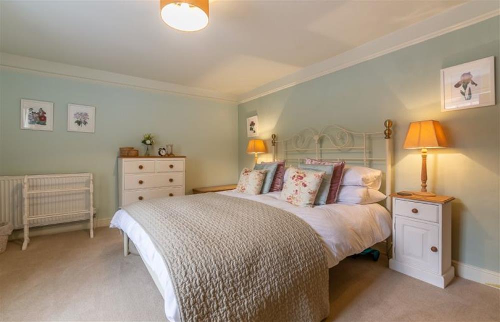 First floor:  Master bedroom with king size bed at Yew Tree Cottage, Blakeney near Holt