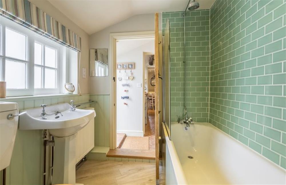 Ground floor:  Bathroom with bath with shower over at Yew Tree Cottage, Blakeney near Holt