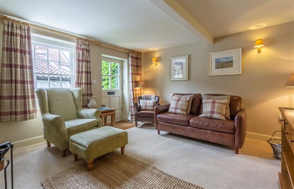 Ground floor:  Sitting room with comfy leather sofa and armchair at Yew Tree Cottage, Blakeney near Holt