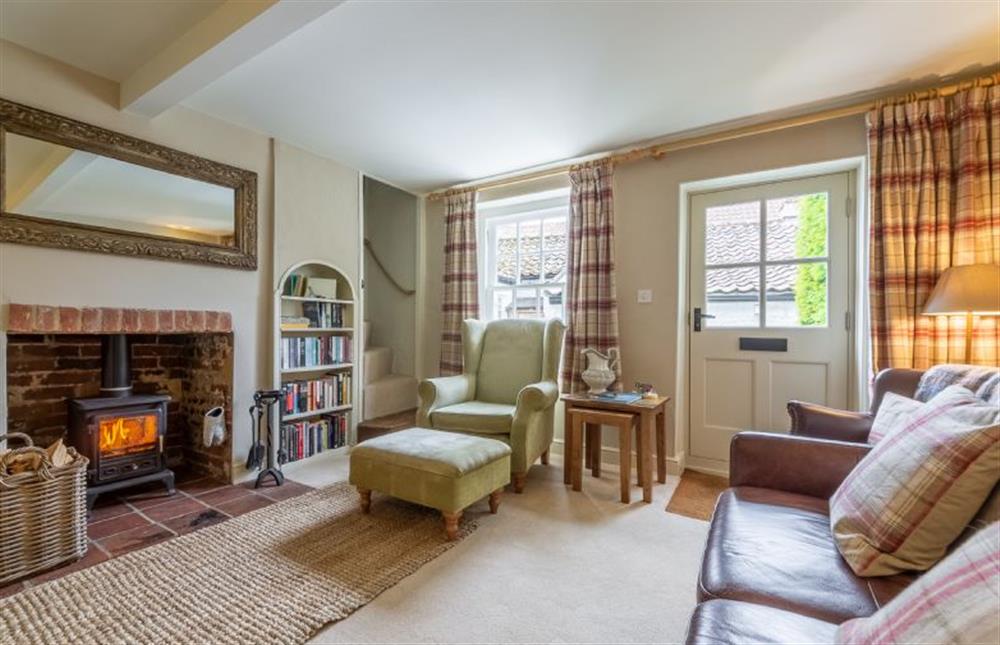 Ground floor:  Sitting room with feature fireplace surround and wood burning stove at Yew Tree Cottage, Blakeney near Holt