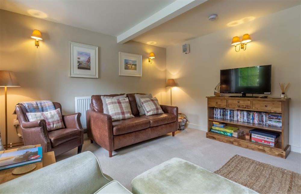 Ground floor:  Sitting room with leather sofa, armchair and flatscreen television at Yew Tree Cottage, Blakeney near Holt