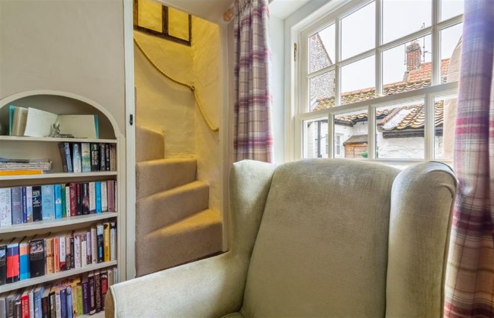 Ground floor:  Sitting room with Norfolk winder stairs at Yew Tree Cottage, Blakeney near Holt