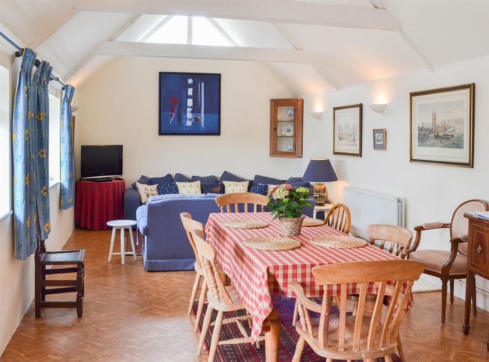 Spacious open plan, living/dining room with a vaulted beamed ceiling at Yew Tree Cottage in Cheriton, near Alresford, Hampshire
