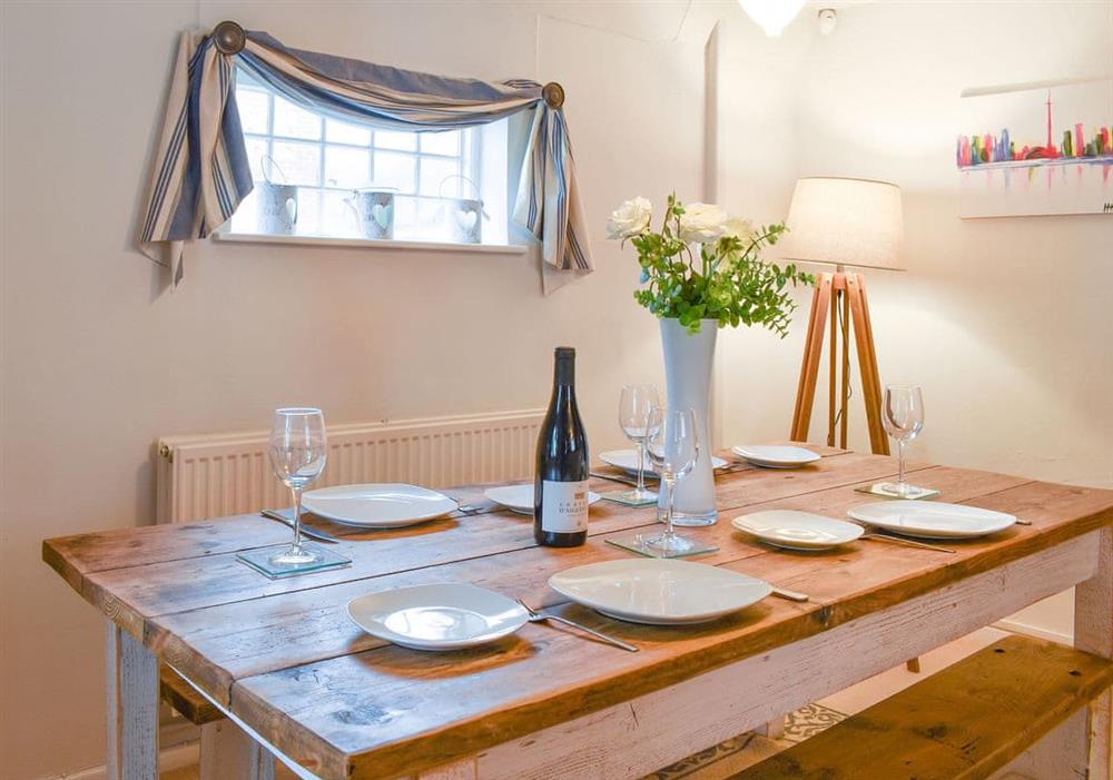 Dining area with bench seating at Yew Tree Cottage in Farnham, near Blandford Forum, Dorset