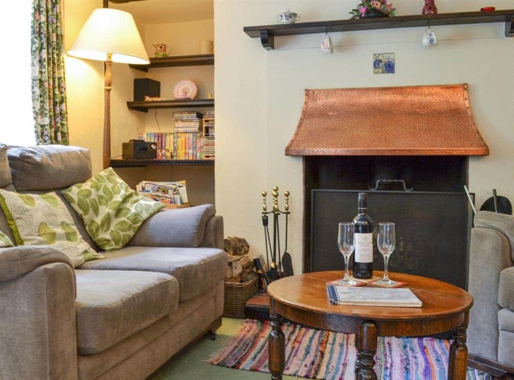 Cosy living room with an open fire in living room at Yew Tree Cottage in Passfield Common, near Liphook, Hampshire