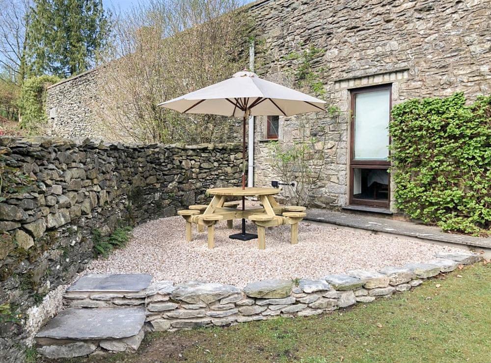 Outdoor furniture on the enclosed lawned garden at Yew Tree Farm in Low Newton, Cumbria