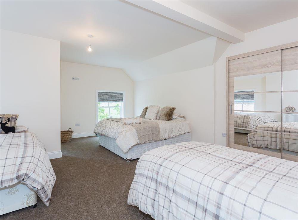 Family bedroom with two single beds at Yokefleet Cottage in Sandholme, near Beverley, North Humberside