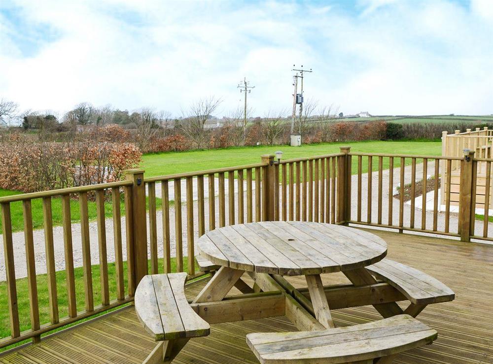 Decking area with views of the surrounding area at Yonder Green Lodge in St. Ervan near Padstow, Cornwall