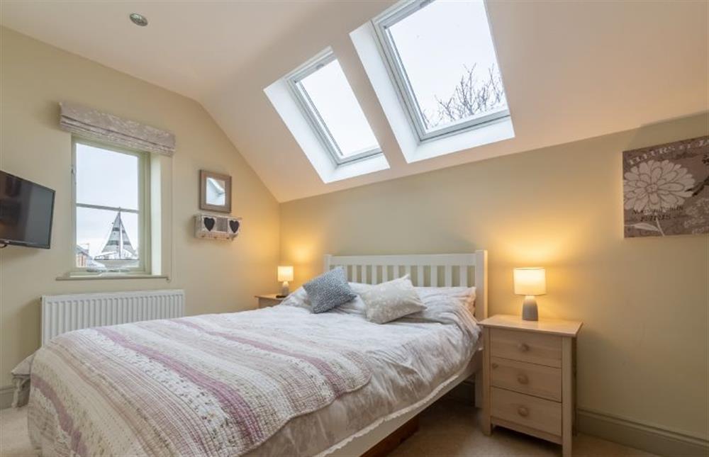 First floor: Bedroom two with double bed and television at York Cottage, Docking near Kings Lynn