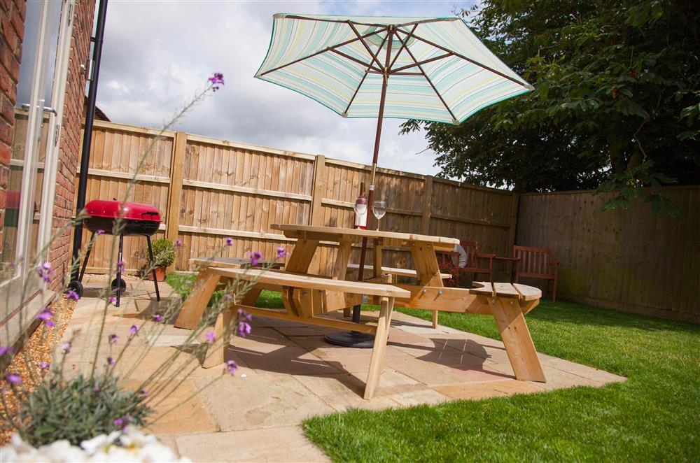 The garden has patio area with barbecue and seating at York Cottage, Docking near Kings Lynn