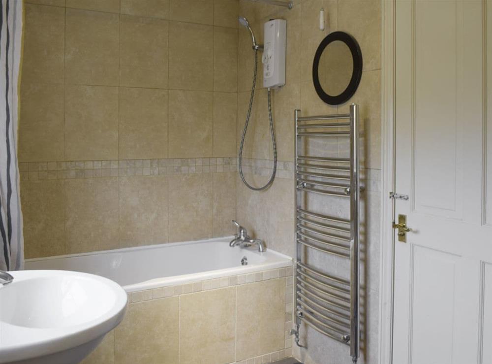 Family bathroom with shower above bath at York House in Hudswell, near Richmond, North Yorkshire