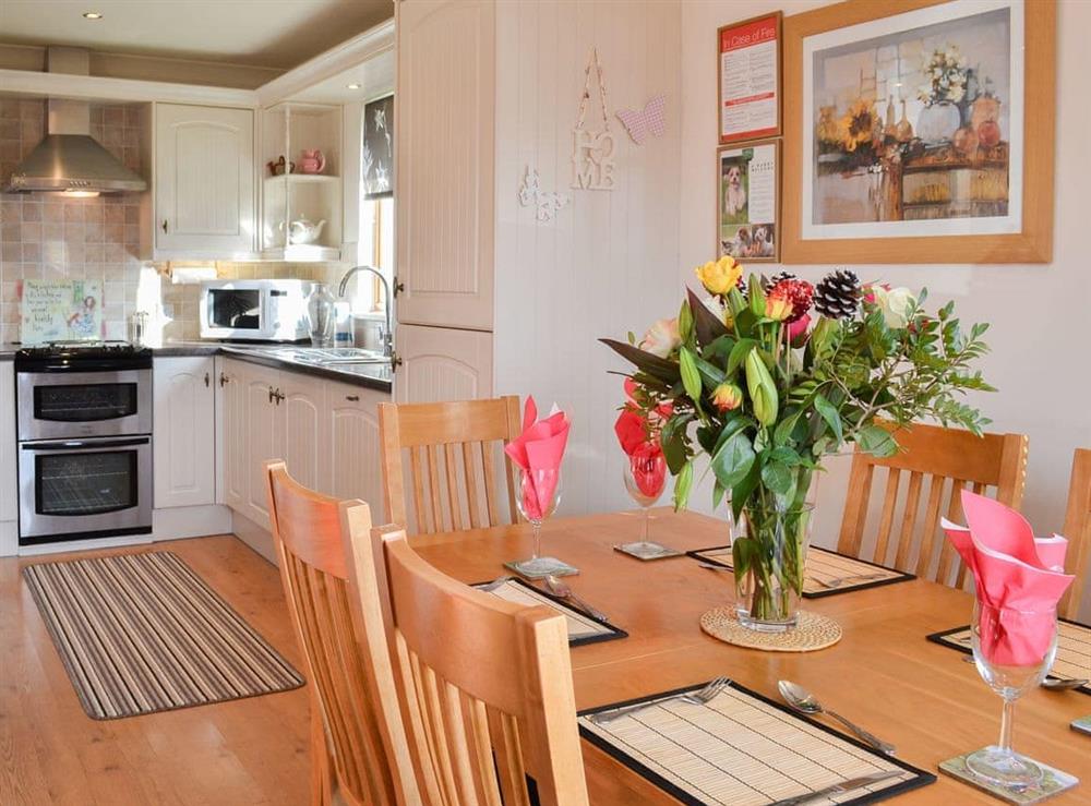 Dining table and chairs through to the kitchen at Yorkshire Rose in Sewerby, near Bridlington, Yorkshire, North Humberside