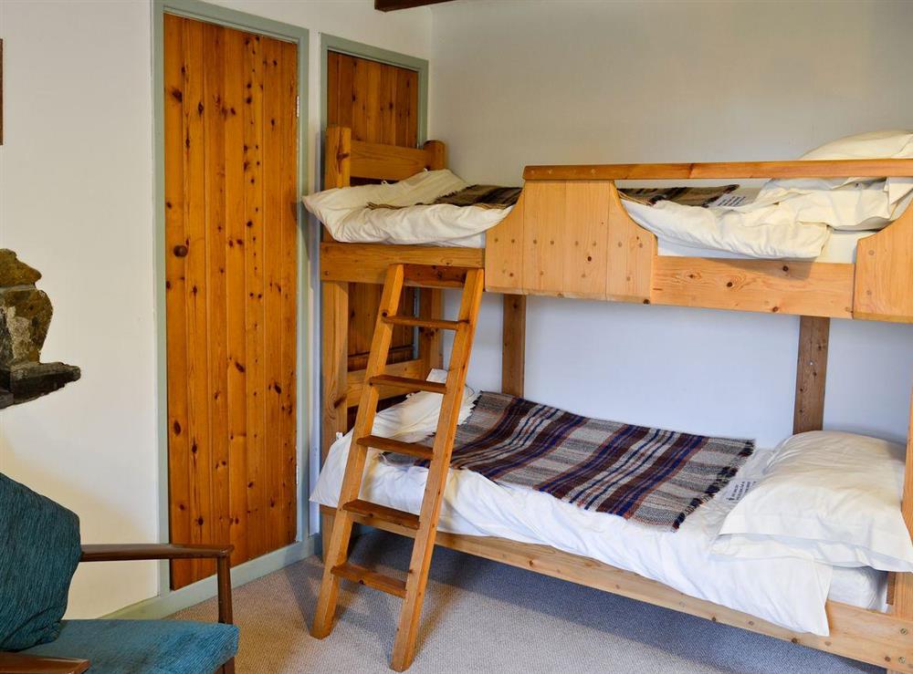 Bedroom with double bed and bunk beds (photo 2) at Yr Hen Stabl in Arthog, near Dolgellau, Gwynedd