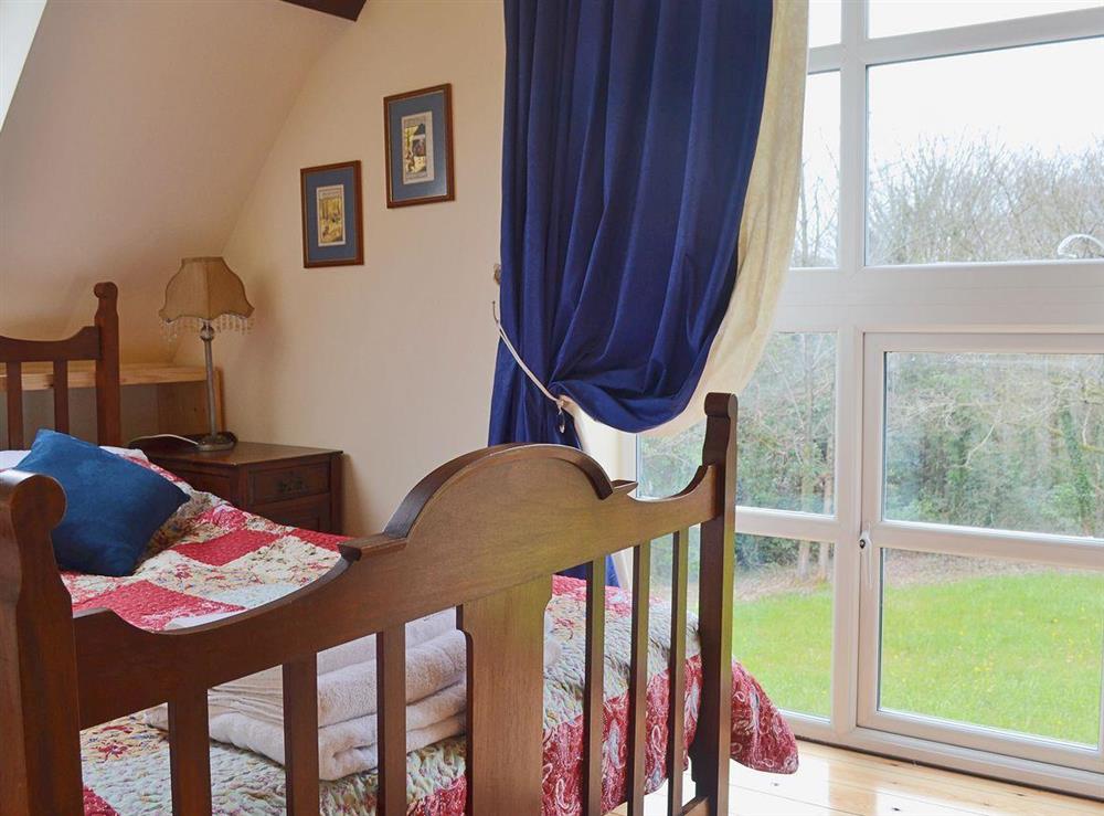 A large full length window lets light flood into the double bedroom at Yr Wyddfa in Caernarfon, Gwynedd