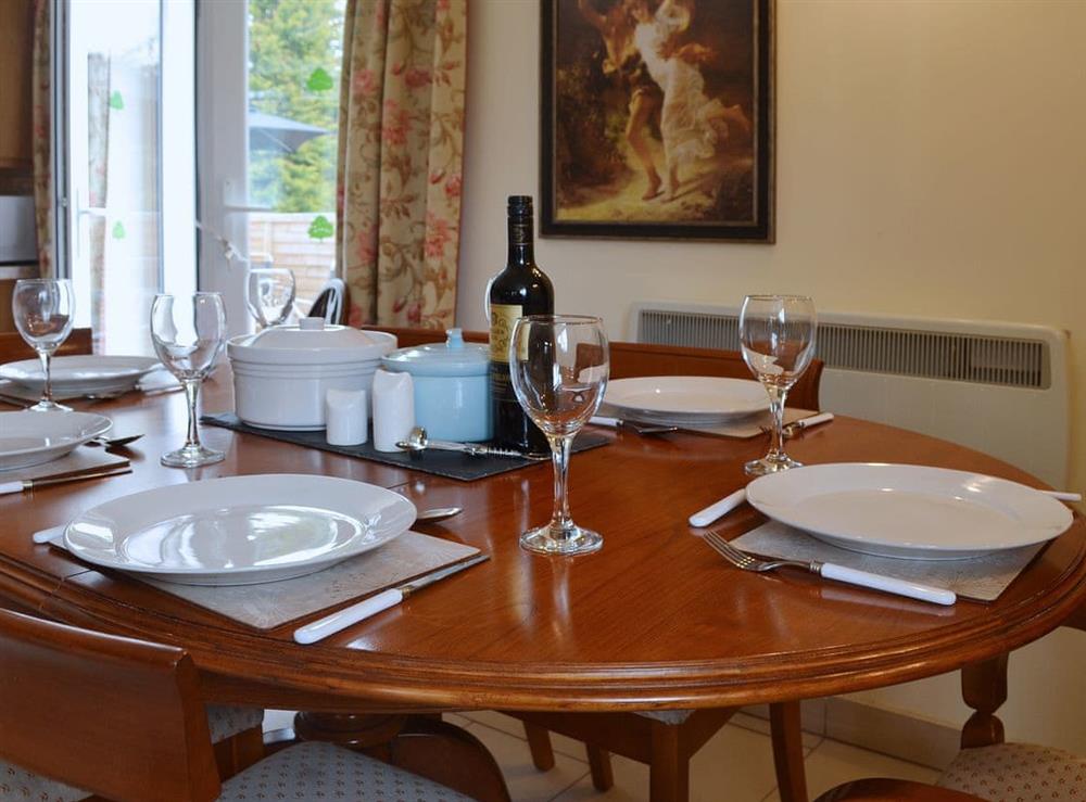 An oval dining table gives a formal air to mealtimes at Yr Wyddfa in Caernarfon, Gwynedd
