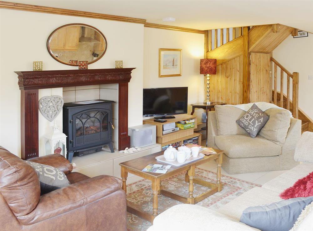 Spacious living area with feature fireplace and electric woodburner at Yr Wyddfa in Caernarfon, Gwynedd