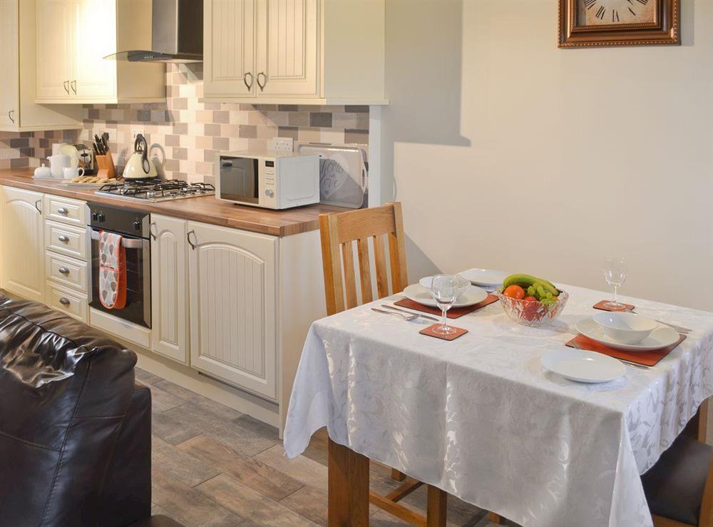 Intimate dining area in open-plan room at Ysgubor Myfi in Bodedern near Holyhead, Gwynedd