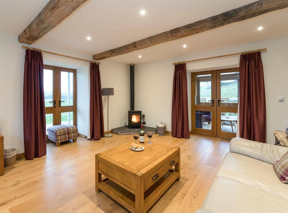 Delightful living room with a cosy wood burner (photo 2) at Ysgubor in Pwllglas, near Ruthin, Denbighshire