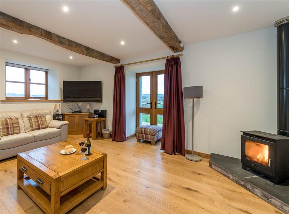 Delightful living room with a cosy wood burner at Ysgubor in Pwllglas, near Ruthin, Denbighshire